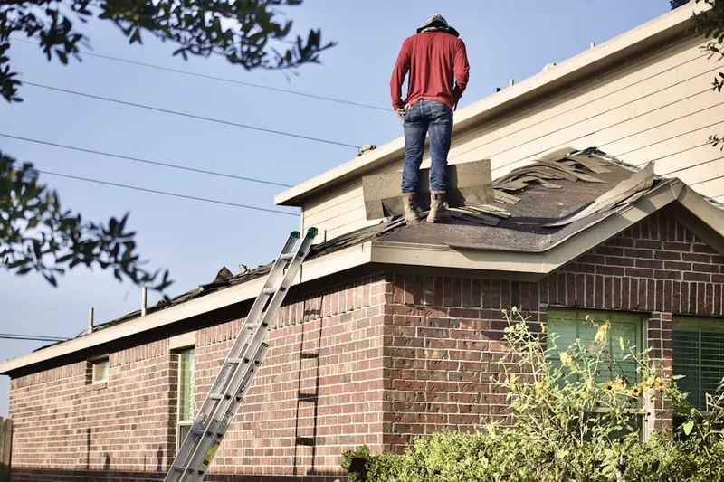 Professional roofer working on a residential roof in Redding